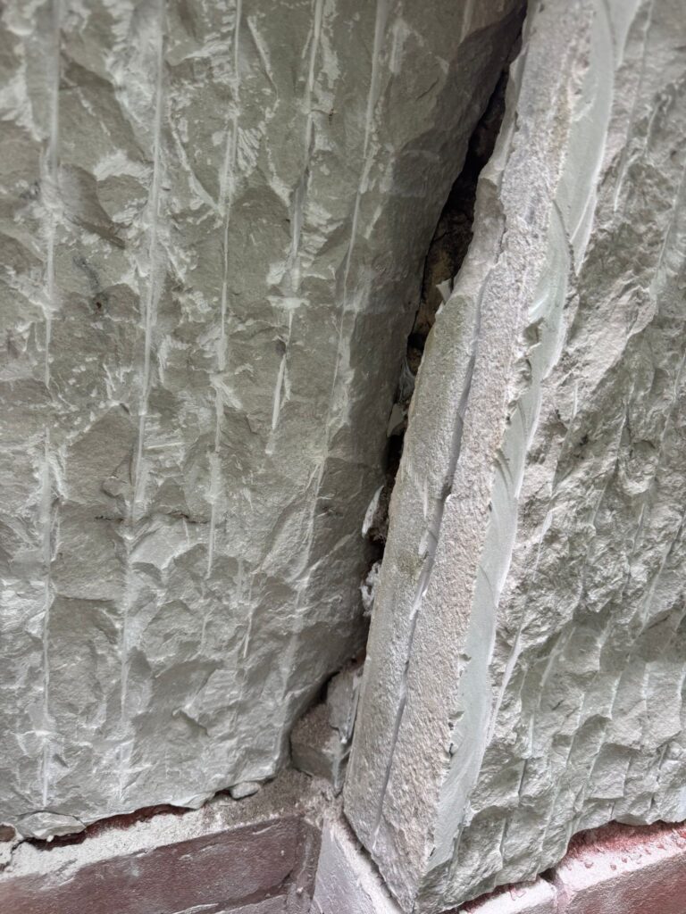 Spalled historic limestone before restoration